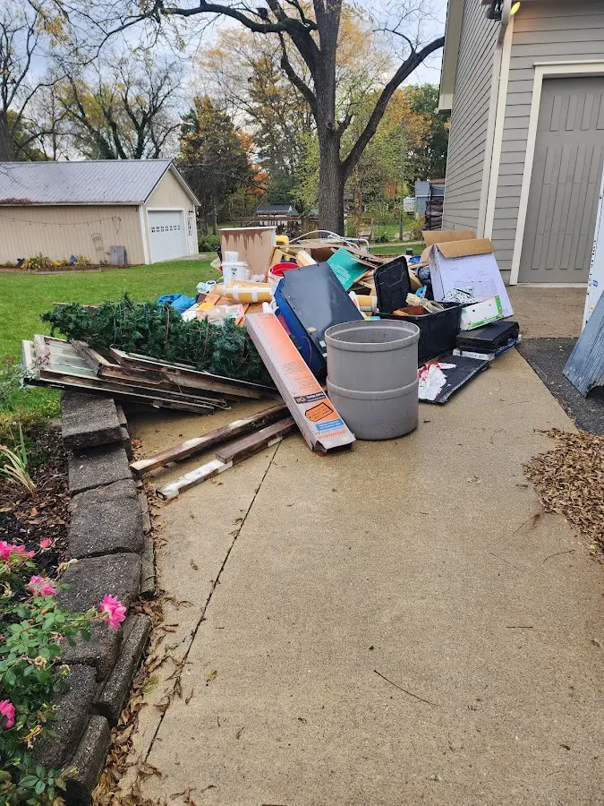 Dumpster being loaded with debris for Residential Dumpster Rental in Brentwood